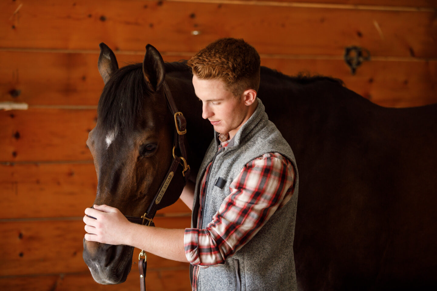 man with horse in barn