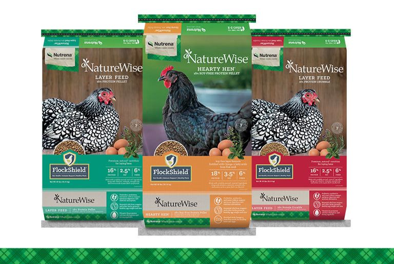 Three Nutrena poultry feed product bags